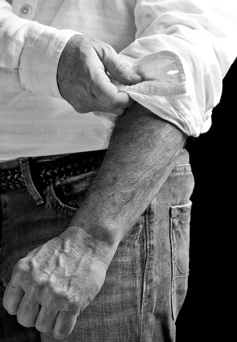 Man casually rolling up sleeve concierge medicine